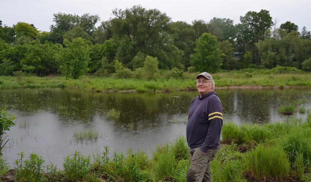 Newly minted conservationist Jeff Tribe poses proudly by the restored wetland. Tribe started the restoration process with a phone call to DUC