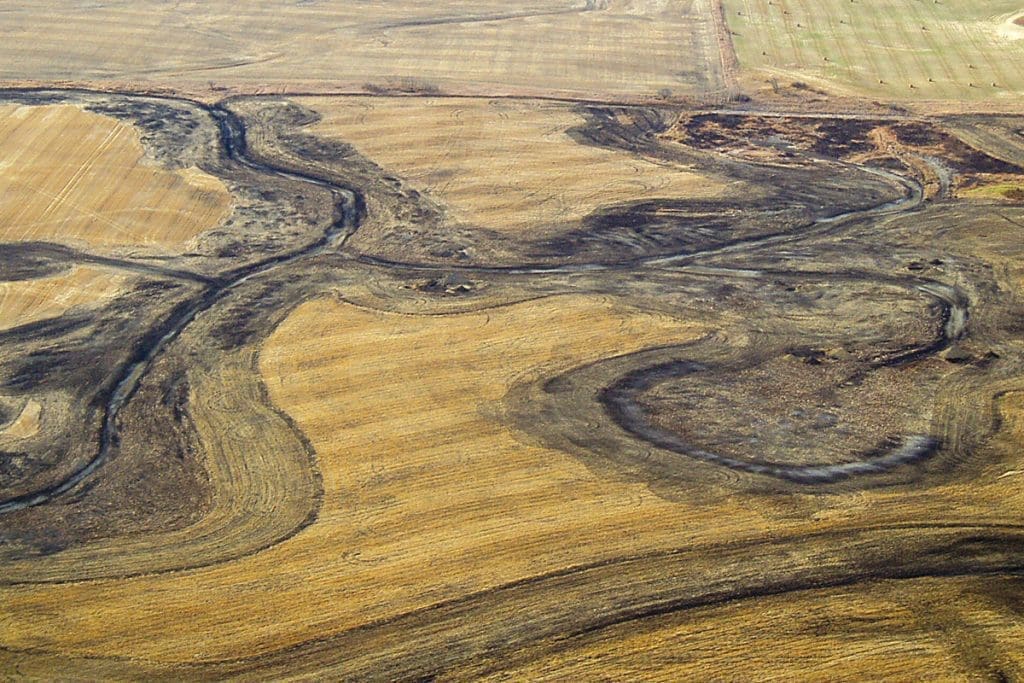 Wetland drainage on agricultural land in the prairies. © DUC