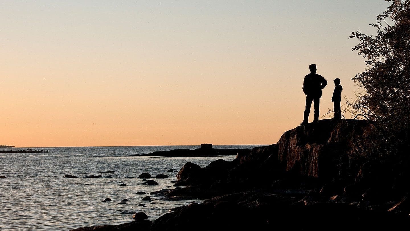 Two people looking out at a lake
