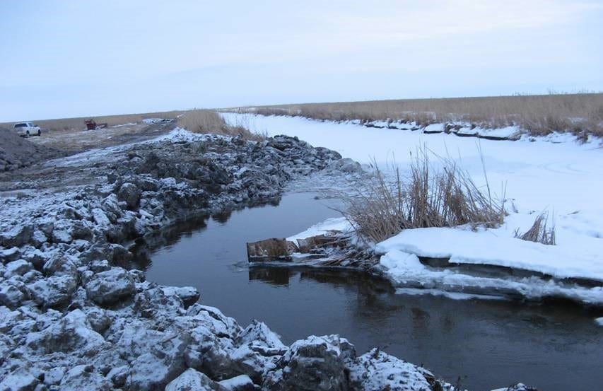 Work crews removed ice from the illegal ditch prior to starting the repair. © DUC