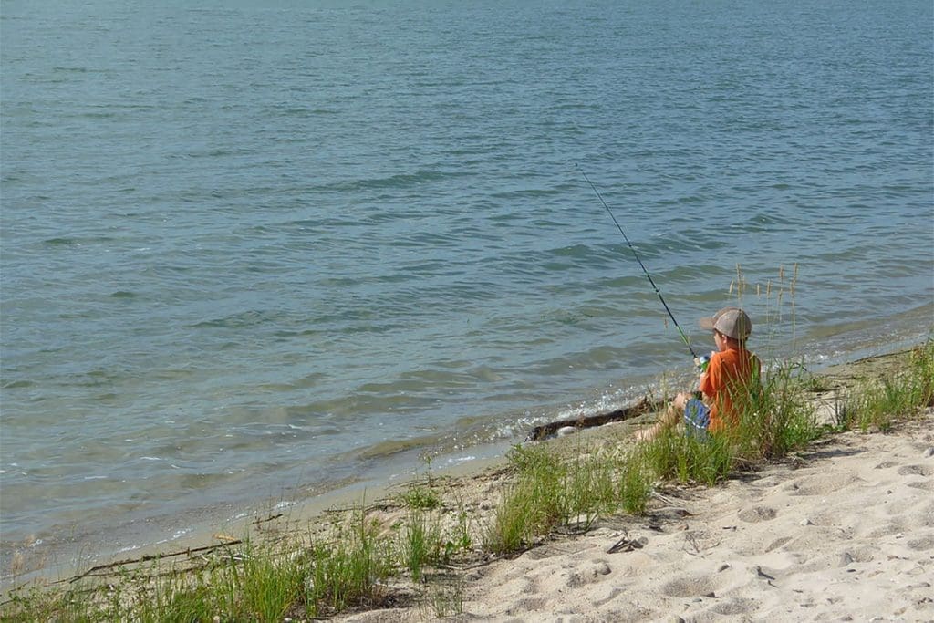 Logan fishing on a beach