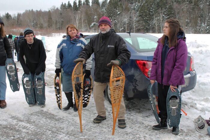 Parks New Brunswick nature educator Ian Smith teaches Saint John high schoolers about snowshoeing.