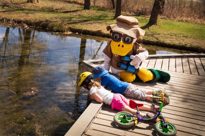 DU Duck and some of the event’s youngest participants take a closer look into the marsh water.