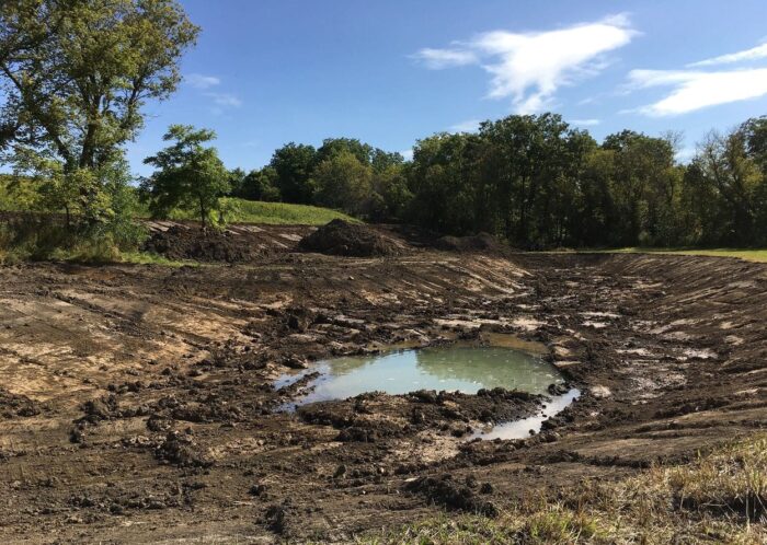 The new ponds immediately at work collecting side-hill seepage flowing toward the river.