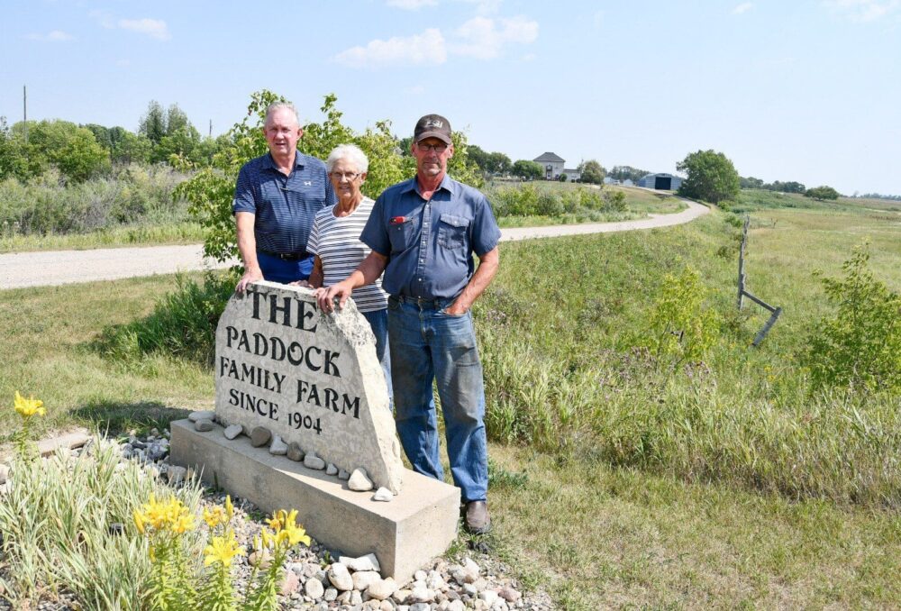 John (left), Alvina and Gord Paddock at their family farm near Oak River, Manitoba. Brothers, John, Gord and Russell Paddock are best known for their achievements in sports, but their roots are in farming. They and their mother are now conservationists too, having signed conservation agreements with DUC.