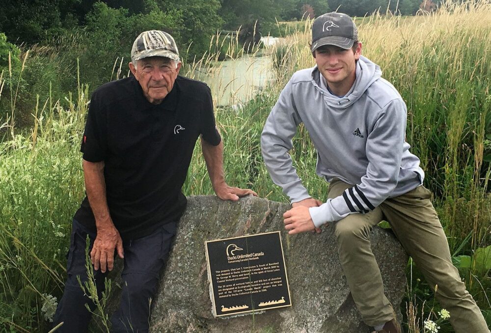 Dr. George Merry and his grandson, Angus, pose with the plaque at LaSalle Marsh honouring his family’s gift of land. 