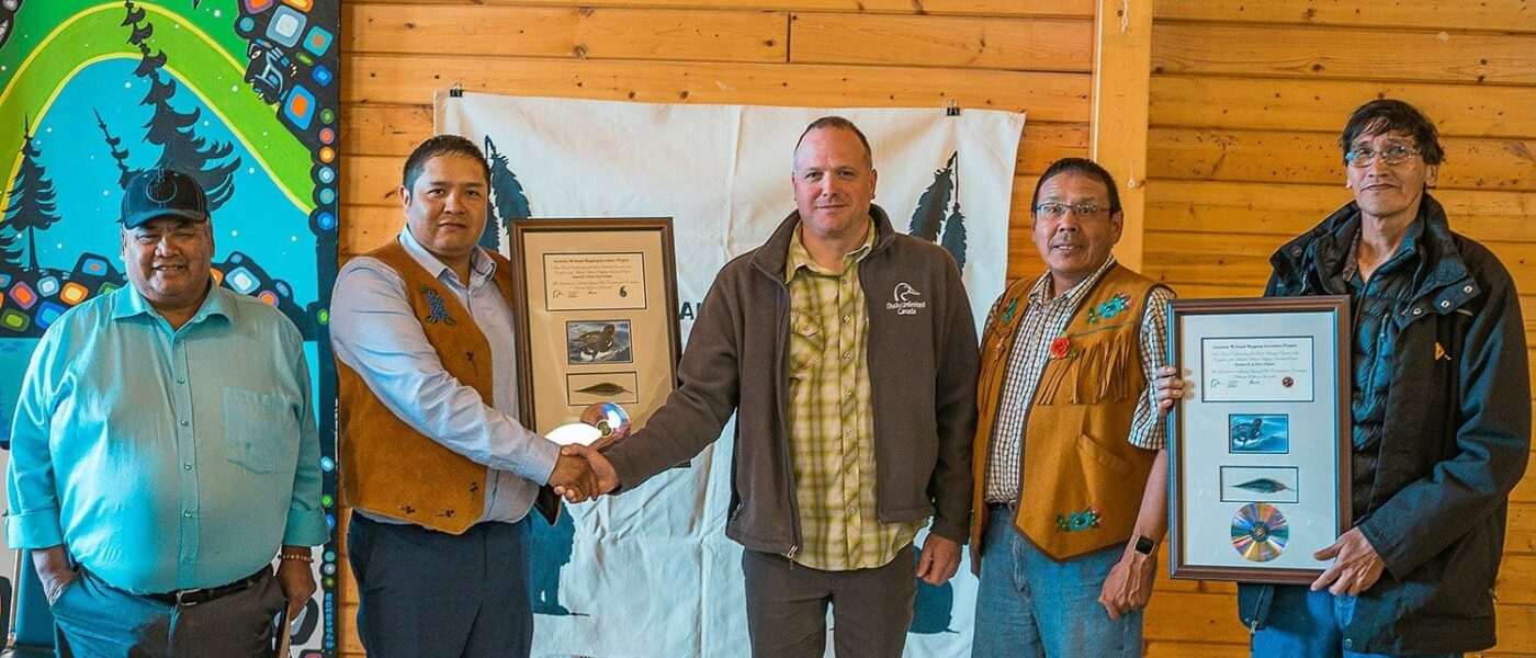 DUC’s Kevin Smith  presents appreciation plaques to the Treaty 8 Tribal Council at the Akaitcho General Assembly. From (L), Chief Edward Sangris, Chief Darryl Boucher-Marlowe, Kevin Smith, Chief Ernest Betsina, and Councillor Pat Simon. Chief Louis Balsillie from Deninu K’ue First Nation was also among the participants. 
