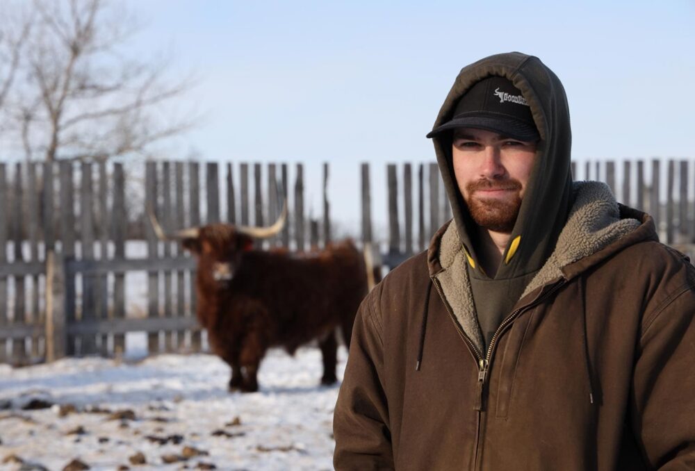 Proudfoot landowner posing with cow in the background