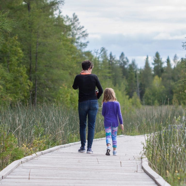 Mother and daughter walking on a dock