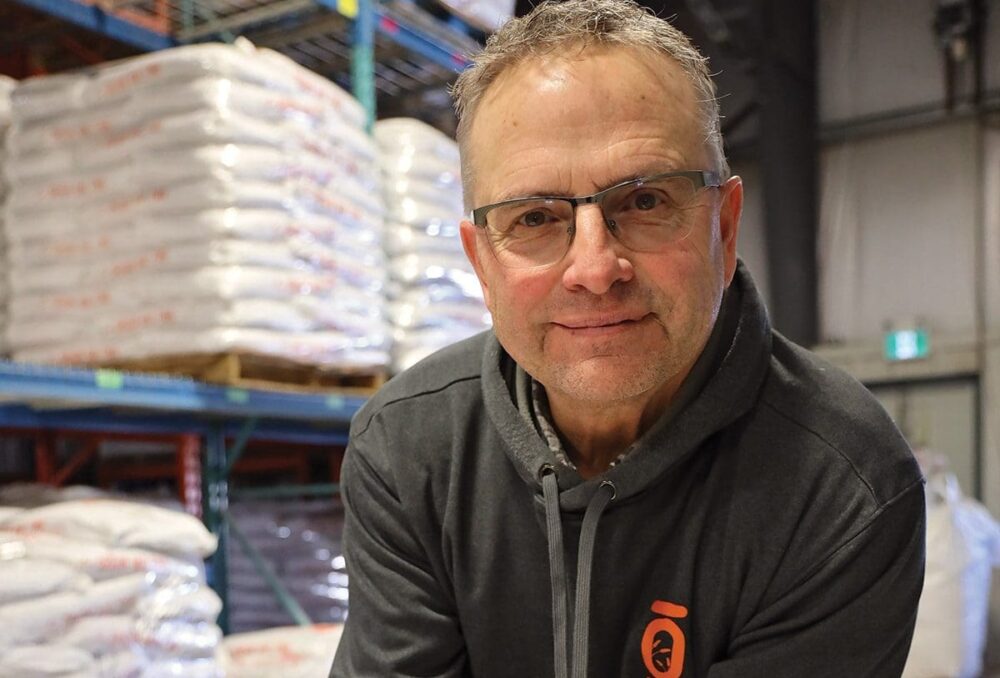 Spencer Hilton with a handful of barley to be used in his family's beer products. The Hiltons employ soil and wetland conservation systems on their farm to enhance the local environment. 