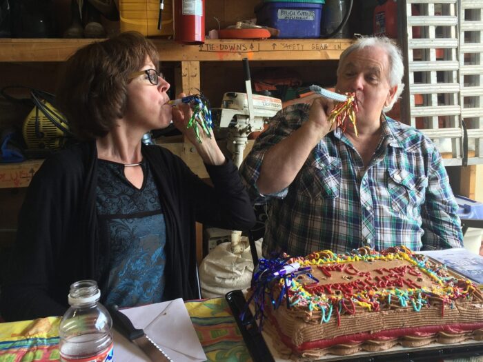 Paul Usher joins fellow DUC employee Patti Erickson as the two celebrate their birthdays at the DUC warehouse in Kamloops.