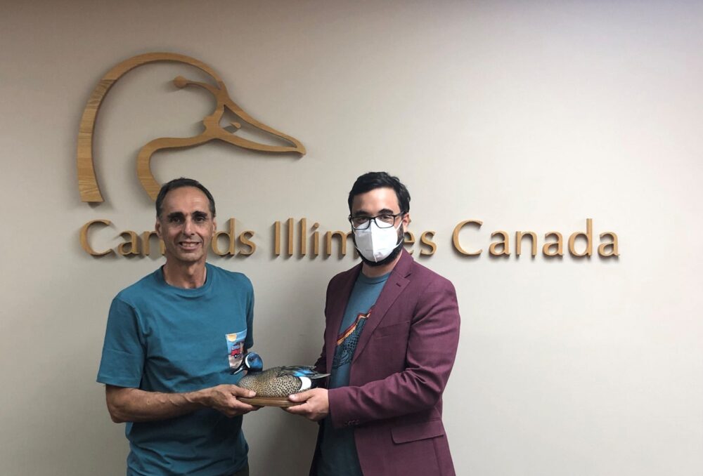 Bernard Filion, left, receives his National Blue-winged Teal Award from incoming DUC provincial manager for Quebec, Sébastien Rioux, June 21, 2021.