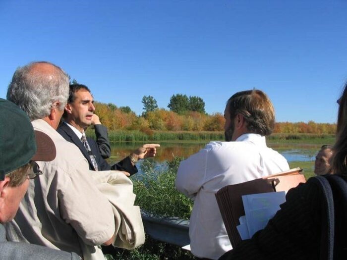 Bernard Filion explains a DUC Quebec project site to a group of visitors.