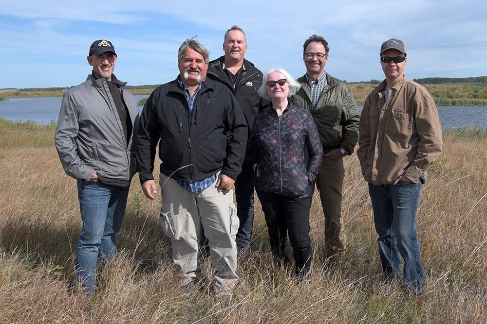 Glen Babee with Ducks Unlimited Canada staff near near Riding Mountain National Park on marsh and grassland that he helped restore.