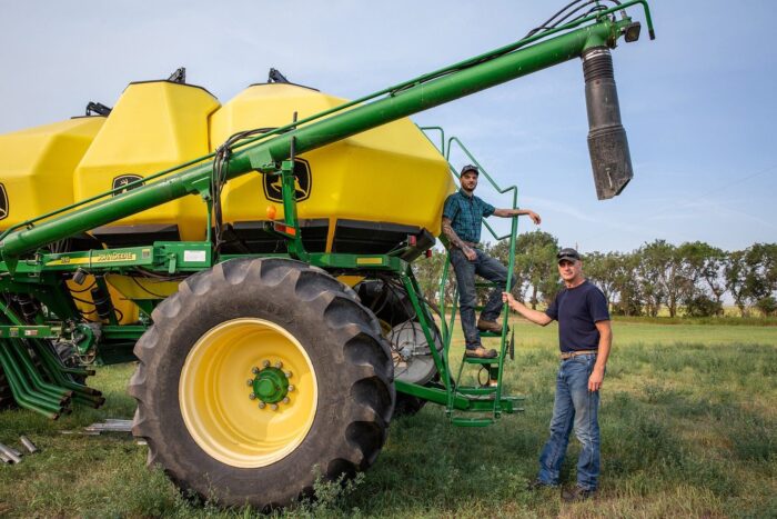 Paul Thoroughgood with his son Nolan on their family farm in Saskatchewan.