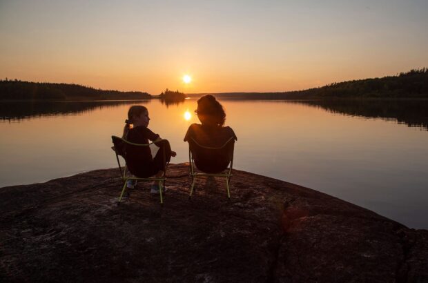 Two people enjoying a Canadian lake