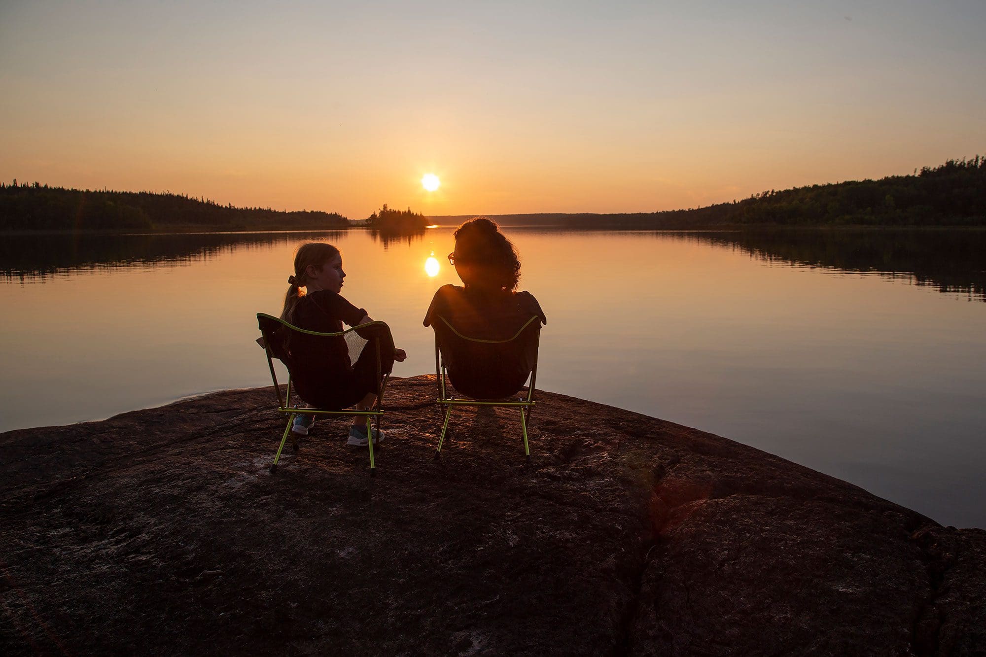 Two people enjoying a Canadian lake