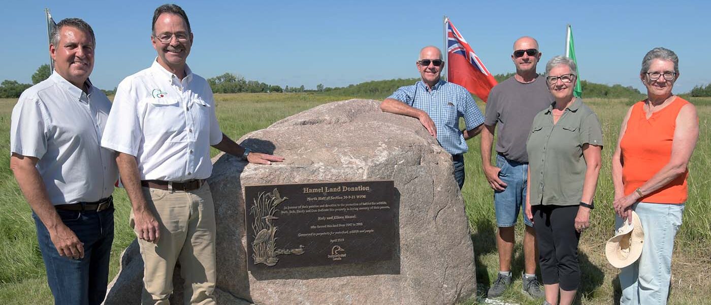 Manitoba deputy premier Cliff Cullen and DUC operations manager Mark Francis with the Hamel family