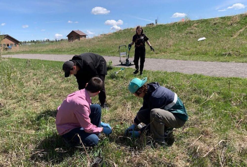 Students from the Edmonton WCE planting native trees at John E. Poole wetland