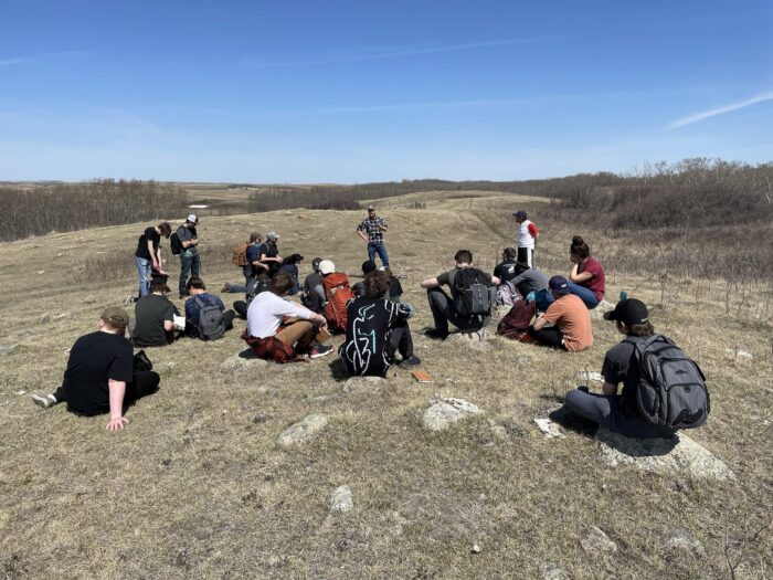 Barry Kaytor (red and white shirt) shares his love of nature with students from Balgonie's Outdoor School on one of the Kaytor CEs. He's joined by DUC's Aiden Bateman.