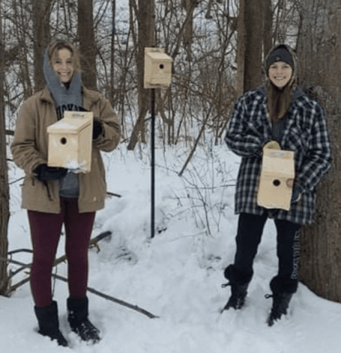 Cattrysse (left) and her classmate installing nest boxes as part of the WCE program.