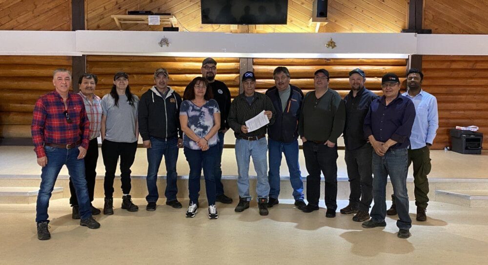 Members of DKFN and FRMG along with members of supporting organizations stand with the newly signed Memorandum of Understanding solidifying the collaborative relationship to developing a new Indigenous Protected and Conserved Area (IPCA) including from left to right: Don Balsillie, Lloyd Cardinal, Teagan Larocque, Dean McKay, Minnie Whimp, Brad King, FMRG Metis President Arthur Beck, Warren Delorme, Sonny Lenoir (DUC), Kris Brekke (CPAWS), Grand Chief Herb Norwegian (Dehcho FN), and James Varghese (DUC)    