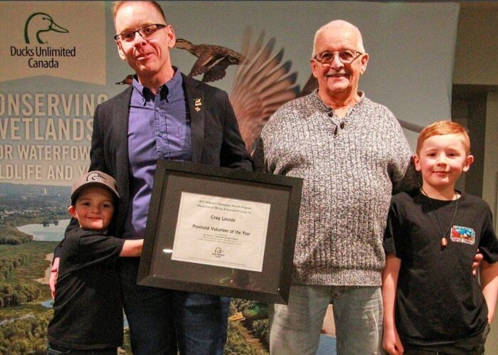 Craig Lalonde with his family as he receives a certificate recognizing him as DUC's Volunteer of the Year in Ontario. 