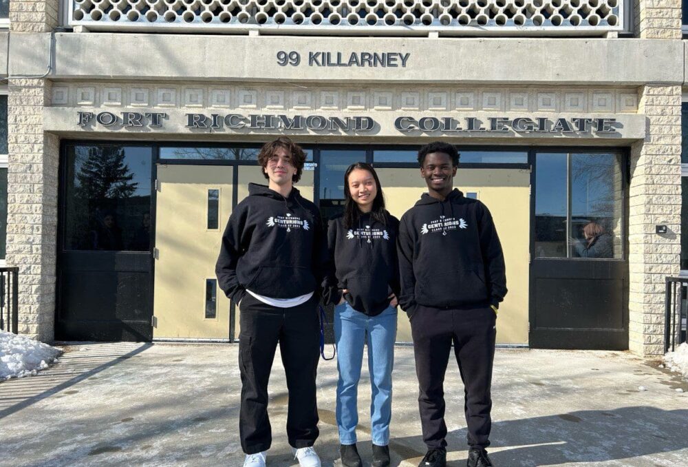 Winning students Sotiris, Ophelia and David pose in front of Fort Richmond Collegiate in Winnipeg, Man.