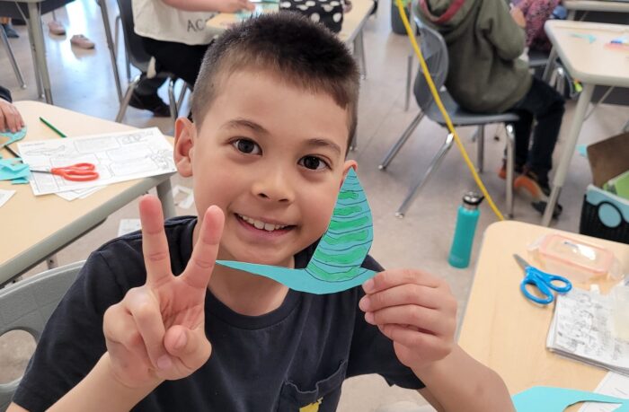 Grade 3 student at the Saskatoon Wetland Centre of Excellence shows off his art project, a yellow-billed cuckoo