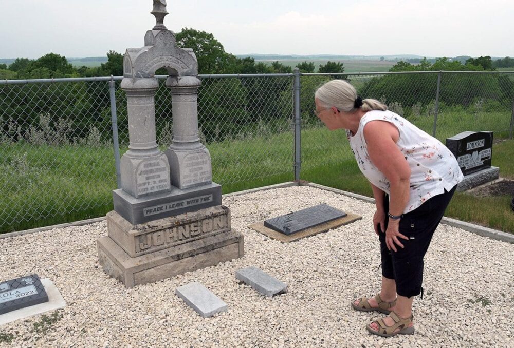 Carol Chapman inspects her great grandparents grave marker