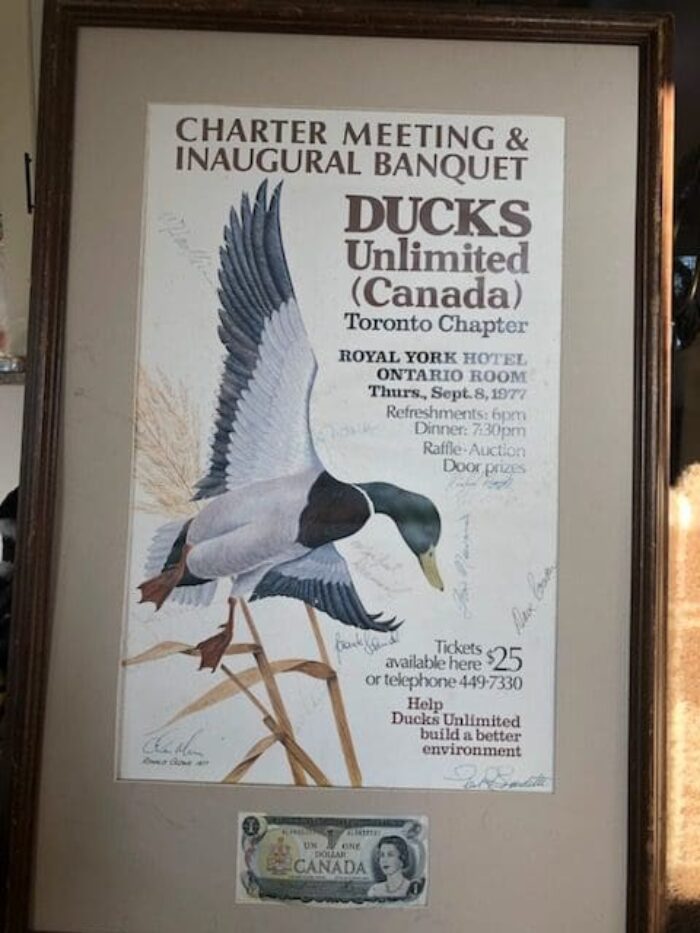 A framed souvenir: The first Toronto DUC dinner poster and, beneath it, the first dollar raised by Myers and the 