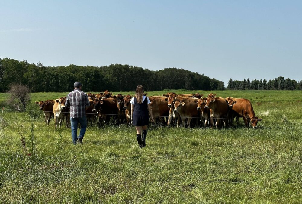 Sean Smith leads a visitor on a tour of his farm, which showcases his family's commitment to sustainability.