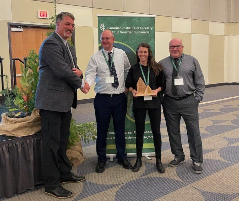 Left to right  Doug Reid, President CIF-IFC, Allan Bell, Tolko Industries, Kylie McLeod, Ducks Unlimited Canada, Bob Mason, Canfor. Bell, McLeod and Mason accepted the CIF award on behalf of the  Forest Management and Wetland Stewardship Initiative.