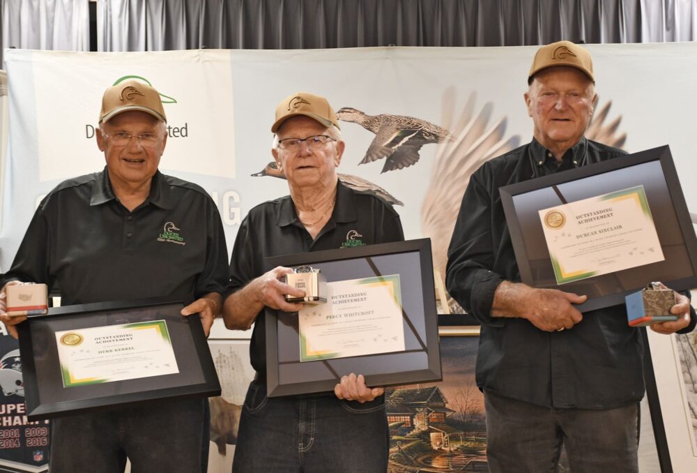 Left to right: DUC volunteers Herb Kebbel, Percy Whitcroft and Dr. Duncan Sinclair with recognition items presented in honour of their 50 years as DUC volunteers.