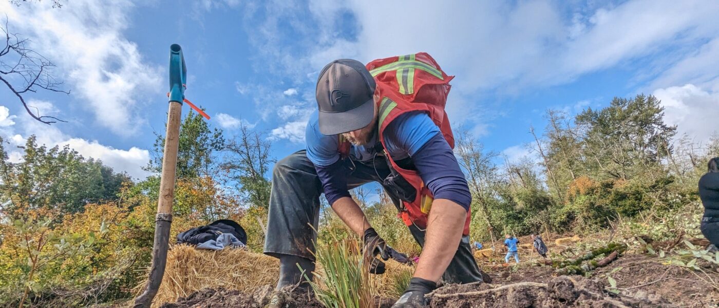 Eric Balke, conservation programs specialist with DUC, plants wetland-friendly plant species as part of the Nature Force event.