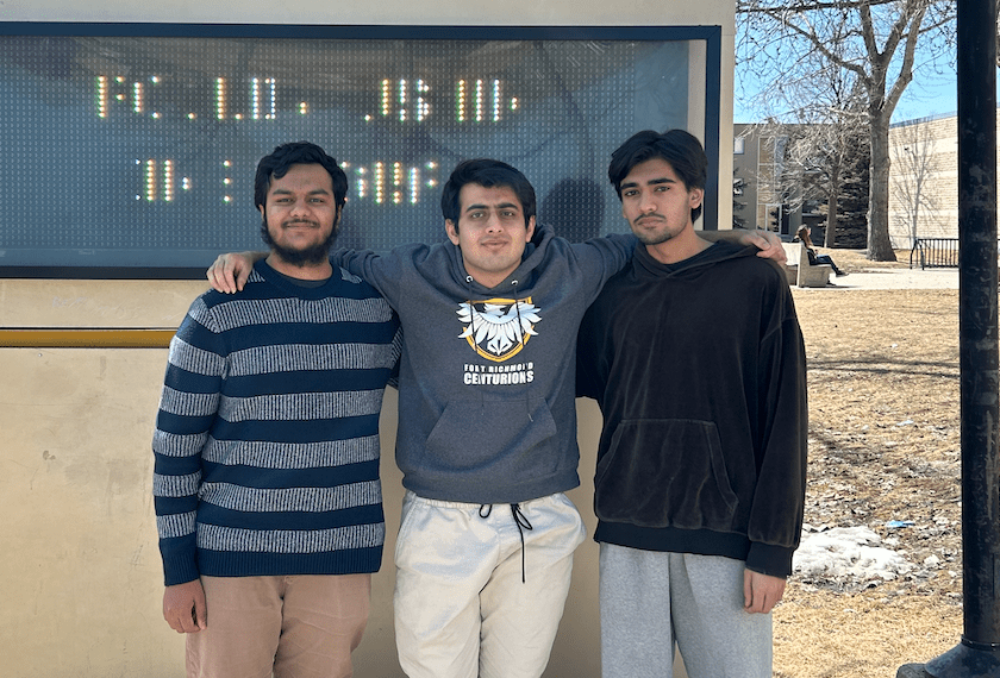 Winners Hamza, Zaid and Haider pose in front of their school, Fort Richmond Collegiate, in Winnipeg