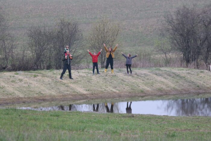 With arms outstretched, the Boyd-Fitzgerald family show their gratitude for their new DUC wetland near Selwyn.