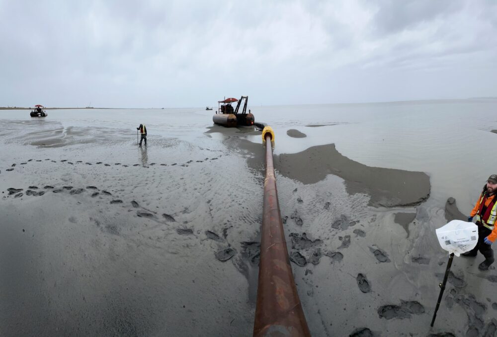 Ducks Unlimited Canada staff perform environmental monitoring and inspect the sediment delivery pipeline which carries the sediment from the barge (not pictured) located in the deeper waters of the Fraser River, to the pilot project site on the foreshore of Sturgeon Bank. Photo taken Sept 25, 2024.