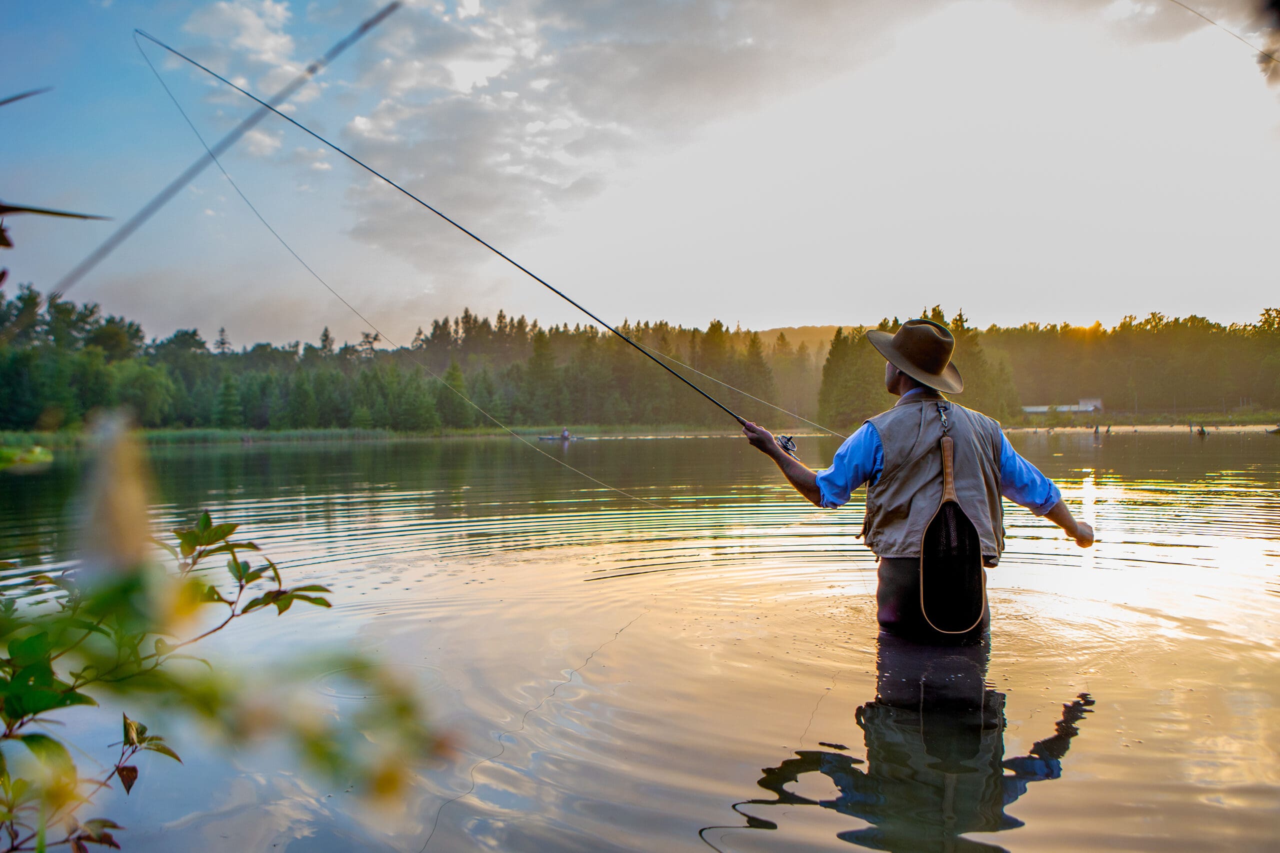 Young man flyfishing at sunrise