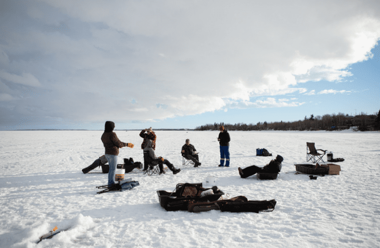 Group of people ice fishing