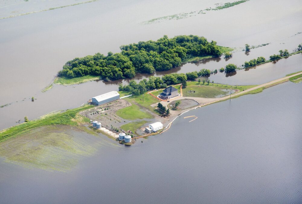 An aerial view of a flooded Canadian home, July 2014. These scenes are becoming more common as wetlands, which can mitigate the damaging effects of flooding, are transitioned to other land uses, while the occurrence of extreme climate events continues to rise.