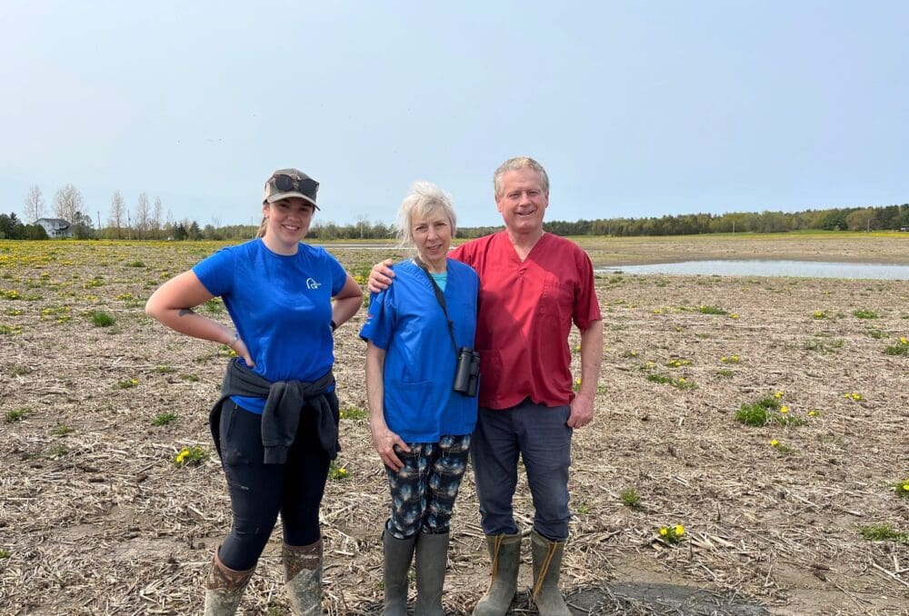 Ducks Unlimited Canada conservation specialist with happy land owners.