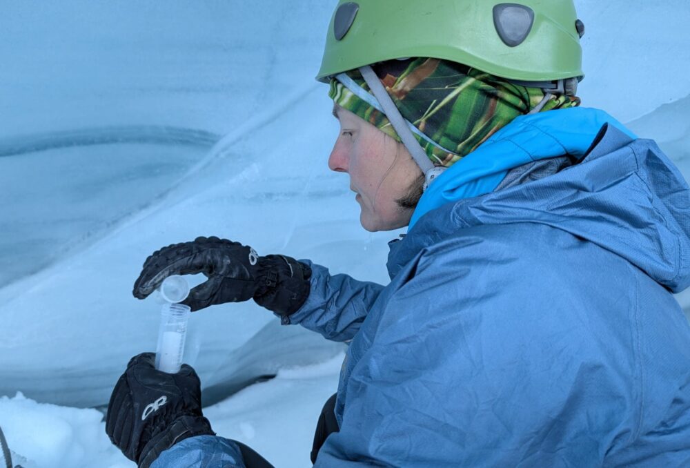 Expedition team member and natural resources expert Emily Moss collects a sample of glacial ice for biological analysis.
