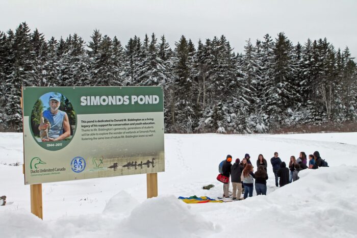 Signage and school group at Ducks Unlimited Canada’s Simonds Pond project.