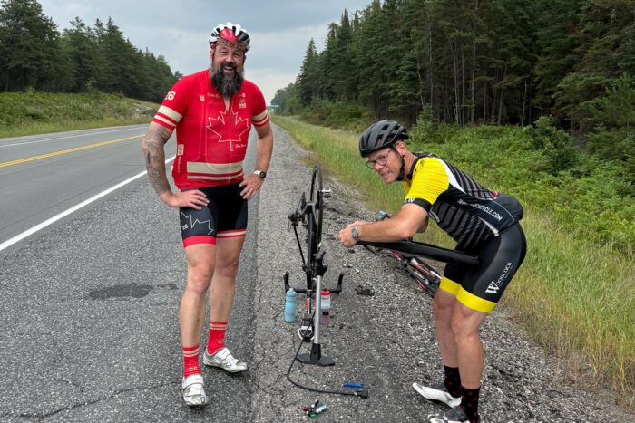 Tim Schroeder gets help fixing a flat tire near the end of Ride to the Lake. “Thankfully, the volunteer from Woodcock Cycle Works was there to ride with me to the end!” he says.